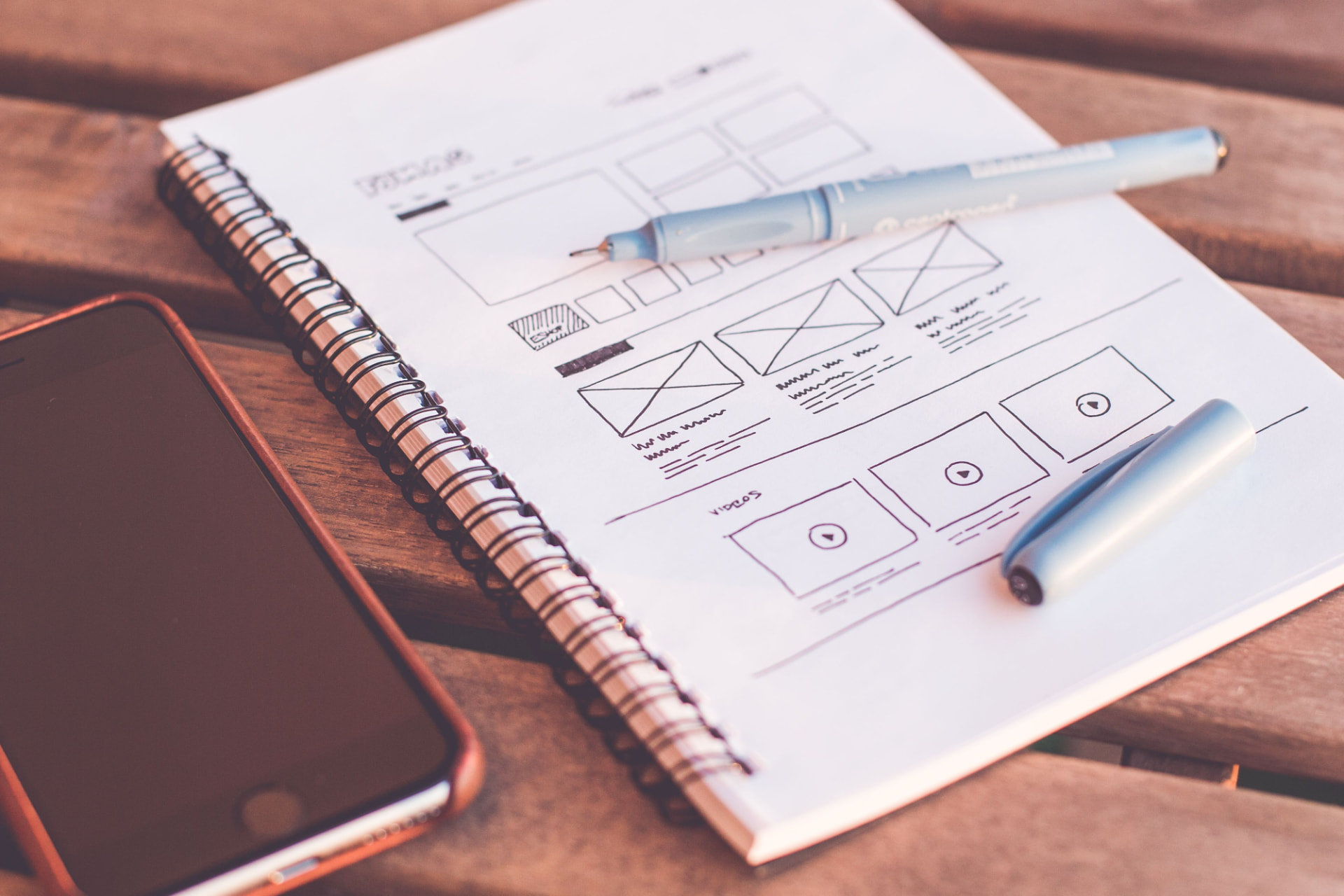 Website wireframes sketched in a notebook